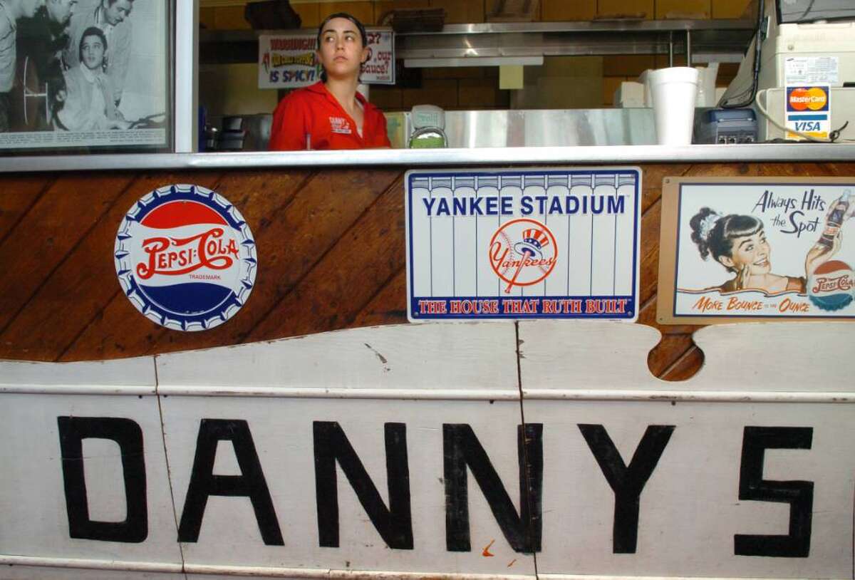 Chrissy Woehrle stands behind the counter at Danny's Drive-In, on Ferry Boulevard in Stratford, Tuesday June 29, 2010. The sign below the counter dates back to the early days of the eatery, in business for 75 years.