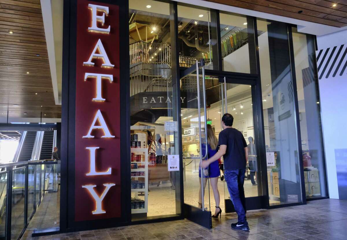 In this Wednesday, Nov. 22, 2017, photo, customers arrive at Eataly at the Westfield Century City Mall in the Century City section of Los Angeles. Many mall owners are spending billions to add more upscale restaurants and bars, premium movie theaters, bowling alleys and similar amenities.