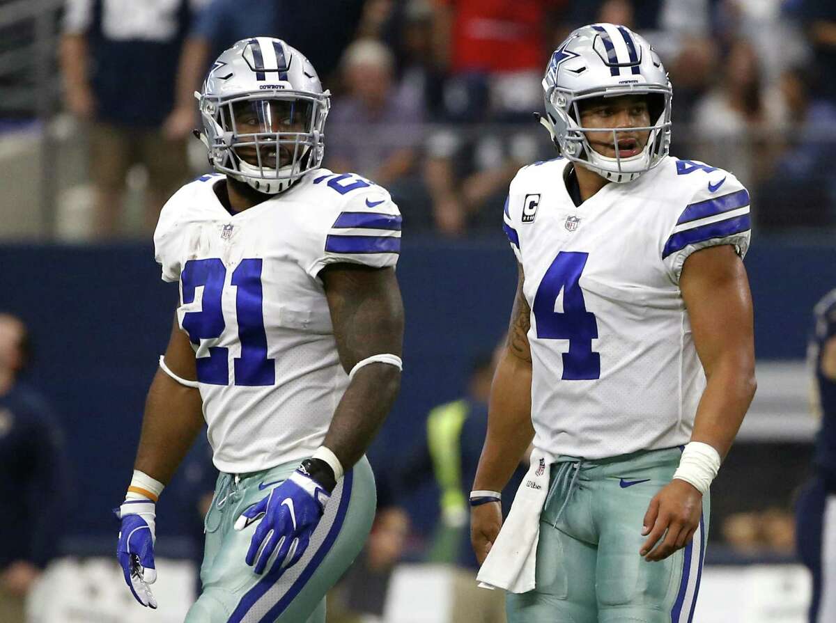 Dallas Cowboys running back Ezekiel Elliott (21) and quarterback Dak Prescott (4) walk off the field Elliott has one game remaining in his six-game suspension, when Dallas travels to Oakland on Sunday night and will be allowed back in the team facility on Monday.