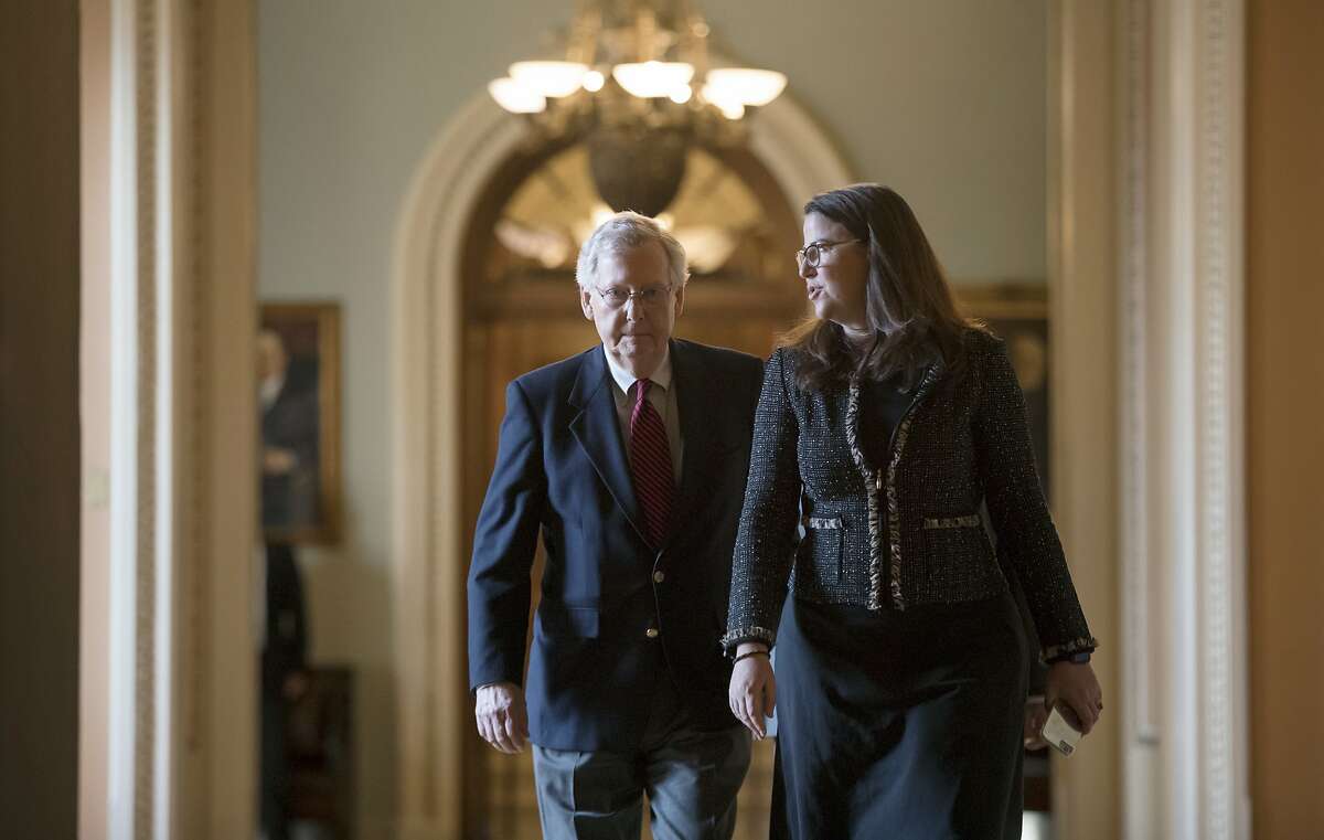 Senate Majority Leader Mitch McConnell, R-Ky., accompanied at right by Secretary for the Majority Laura Dove, walks to his office from the chamber as Republicans in the House and Senate plan to pass the sweeping $1.5 trillion GOP tax bill on party-line votes, at the Capitol in Washington, Monday, Dec. 18, 2017. (AP Photo/J. Scott Applewhite)