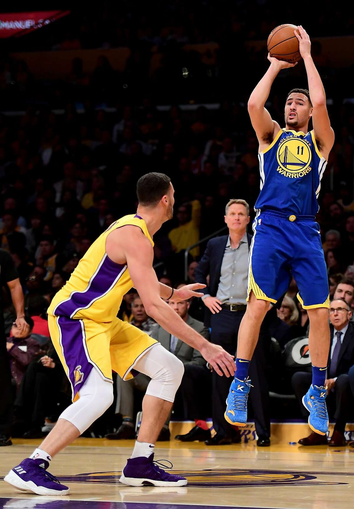 Klay Thompson of the Golden State Warriors shoots over Larry Nance Jr. of the Los Angeles Lakers in the first quarter at Staples Center on December 18, 2017 in Los Angeles, California.