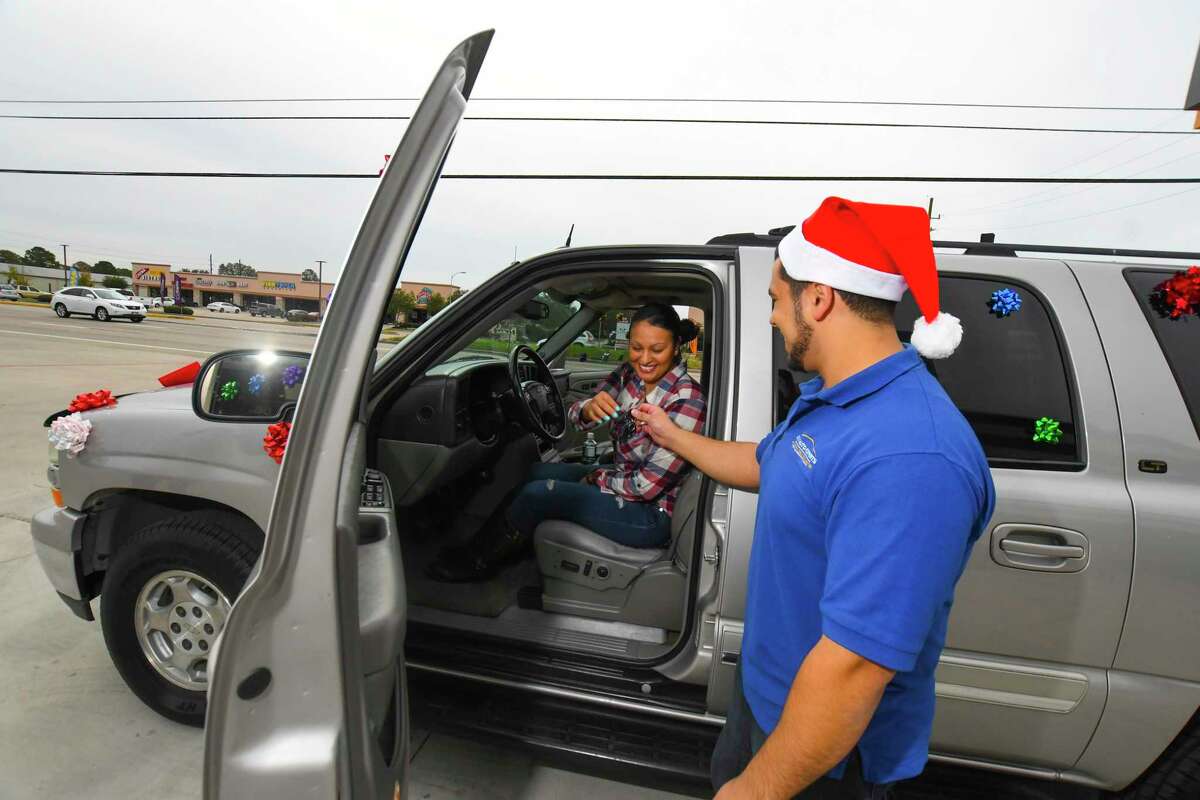 Johanna Gomez gets the keys for her new car from Moe Rabieh. Gomez and her family were given a fully-restored 2004 Chevy Suburban. The vehicle was purchased in auction and filled with gifts for Gomezâs sons, who are ages 14 and 15.