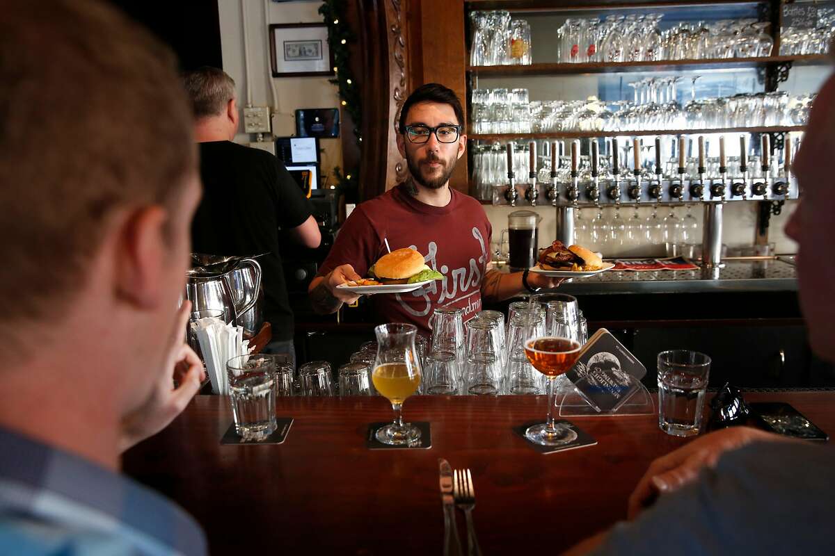 Bryce Bishari serves patrons lunch at Monk's Kettle restaurant and bar in the Mission neighborhood on Monday December 18, 2017, in San Francisco, Ca.