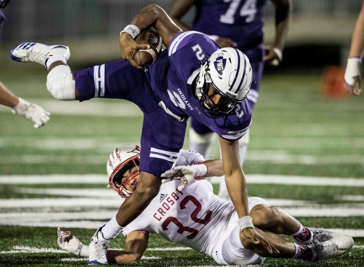 Port Neches-Groves quarterback Roschon Johnson 92) is tripped up by Crosby defender Hunter Bradford (32) during the first quarter of a Class 5A bi-district playoff football game at Stallworth Stadium on Friday, Nov. 17, 2017, in Baytown. ( Brett Coomer / Houston Chronicle )