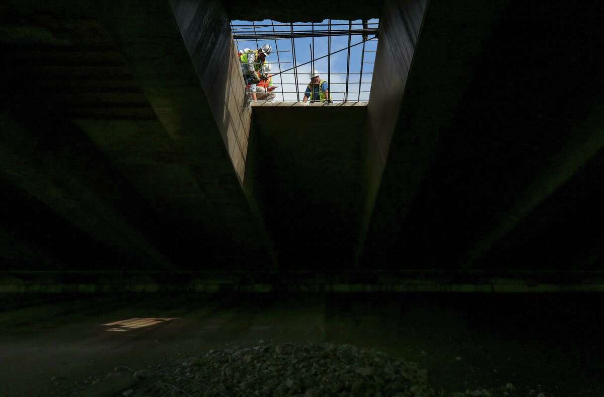 Construction workers repair a collapsed section of the southbound Eastex Freeway, near Little York Road Tuesday, Dec. 19, 2017, in Houston.