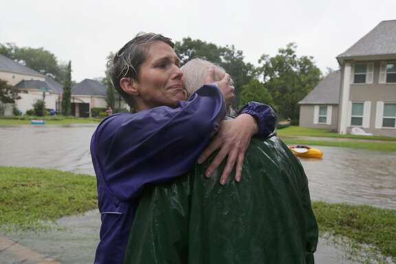 Amanda Ankney hugs her father Byron Gilleon after he was rescued from his homes near Crossroads and Walkwood drives during Tropical Storm Harvey Monday, Aug. 28, 2017, in Houston.
