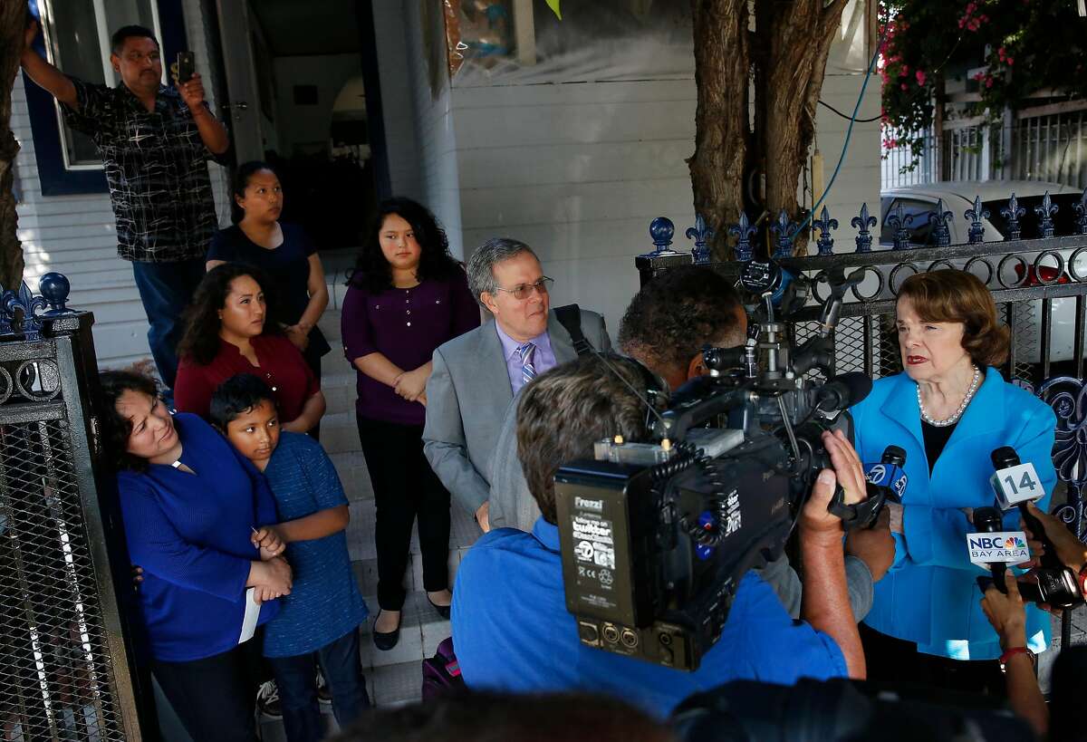 Sen. Dianne Feinstein (right) speaks with the media after meeting with Maria Mendoza-Sanchez and her family: Maria Mendoza-Sanchez, Jesus Sanchez, 12, Vianney Sanchez, 23, Melin Sanchez, 21, Eusebio Sanchez, Elizabeth Sanchez, 16, and their attorney, Carl Shusterman, outside the Sanchez home in Oakland.