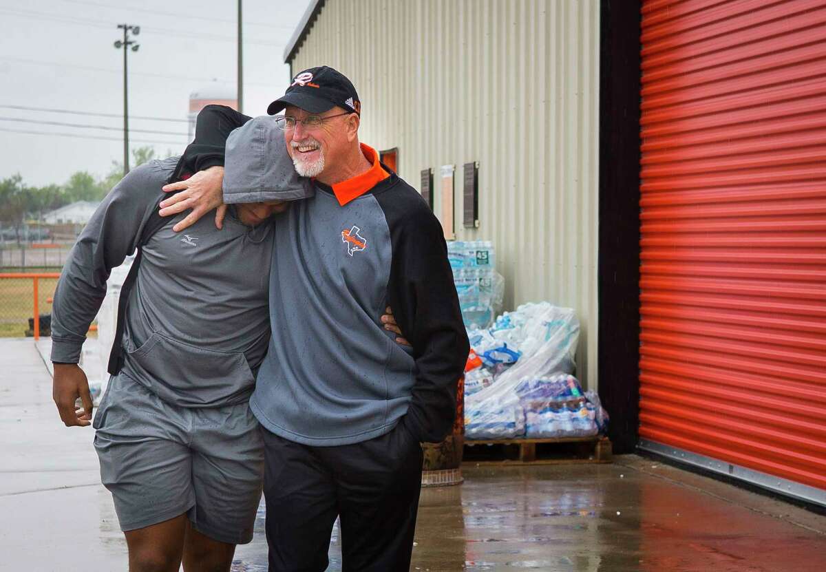 Refugio High School head football coach Jason Herring greets junior lineman Armonie Brown outside of the football facility, Monday, Dec. 18, 2017, in Refugio. Armonie was there to help unload a truck full of donated mattresses and box springs that the football team has been storing in their facility for Hurricane Harvey victims in the small Texas town. ( Mark Mulligan / Houston Chronicle )