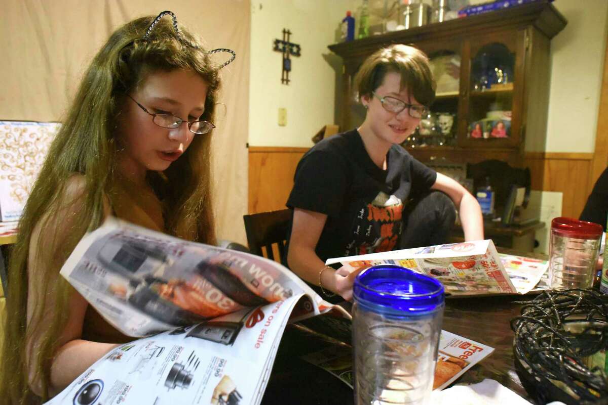Harmonie Flores-Brown, 11, left, relies on the CHIP insurance program to cover the cost of her special glasses, which require a unique prescription.