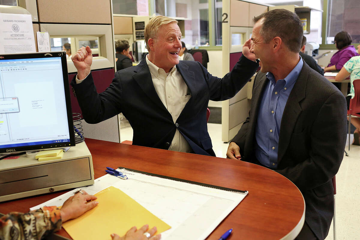 FILE - In this Sept. 25, 2015, file photo, Mark Phariss, left, and Victor Holmes celebrate getting their marriage license at the Bexar County Marriage License Office in San Antonio. Phariss, who sued over the right to marry his partner said Tuesday, Dec. 19, 2017, that he is running as a Democrat in 2018 in a bid that would make him the first openly gay state senator in Texas if elected. (Lisa Krantz/The San Antonio Express-News via AP File)/The San Antonio Express-News via AP)