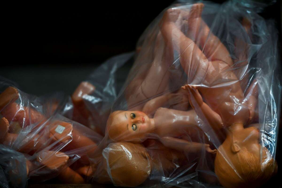 Dolls in plastic bags wait to be delivered after being repaired at the Doll Hospital in Lisbon on December 12, 2017. These delicate toys have been restored or collected with care and affection for five generations, at the "Doll Hospital", a tiny repair shop located in the heart of old Lisbon downtown.
