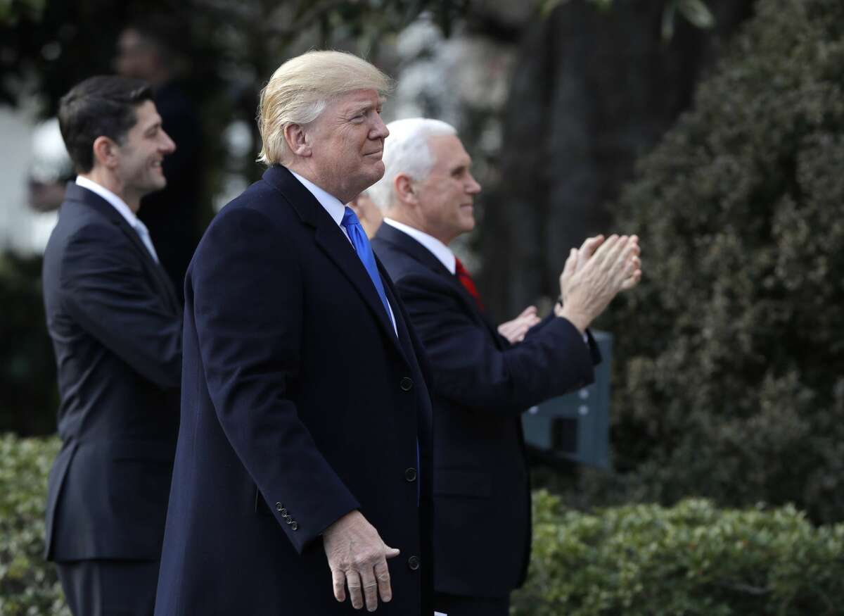President Donald Trump walks with Vice President Mike Pence and House Speaker Paul Ryan, R-Wis., for a event after final passage of the tax overhaul plan, on the South Lawn of the White House, Wednesday, Dec. 20, 2017, in Washington. (AP Photo/Evan Vucci)