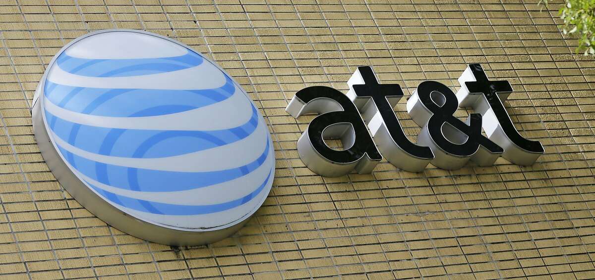 FILE - This Thursday, Oct. 12, 2017, file photo shows an AT&T sign at a store in Miami. 