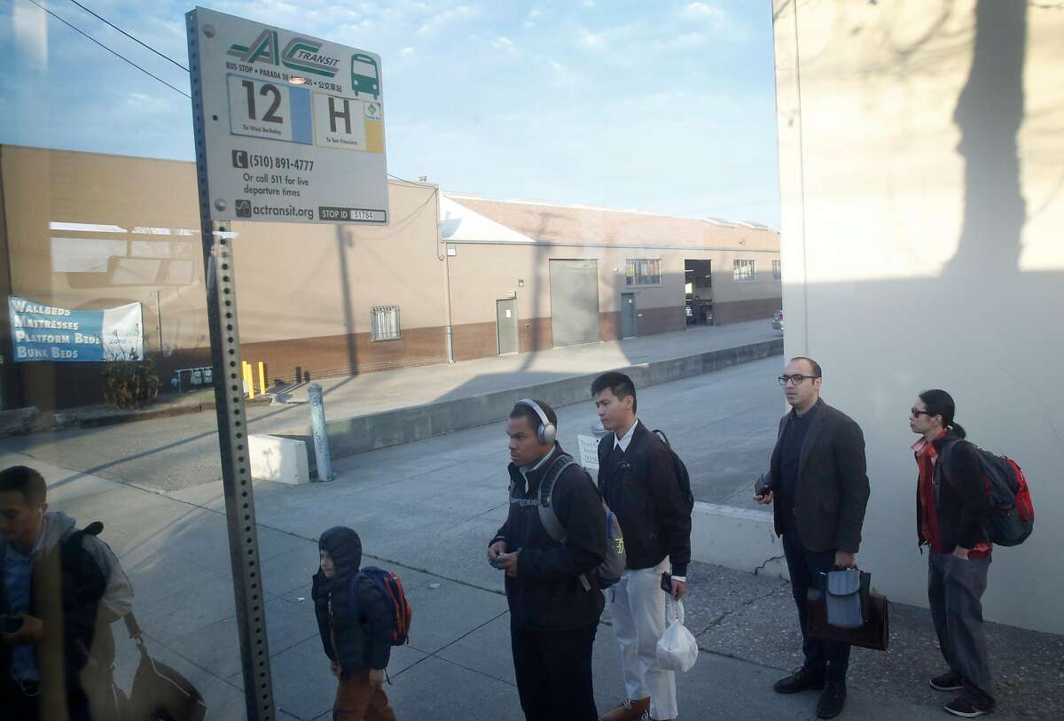 Commuters on Gilman Street in Berkeley board an AC Transit H-line Transbay bus to San Francisco, Calif. on Tuesday, Dec. 19, 2017.