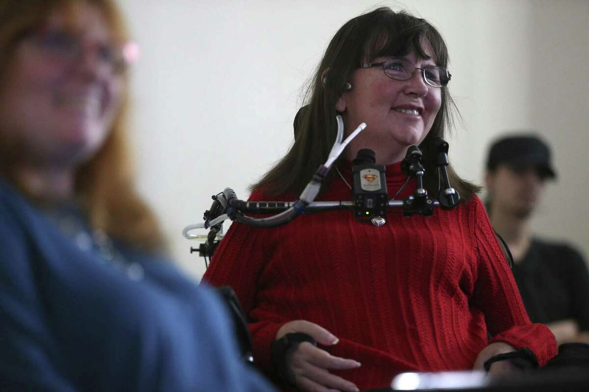 Anne Robinson, 48, reacts as students explain a game designed for her during a presentation at the University of Texas at San Antonio main campus on Dec. 14. Students were tasked with creating a video game for a disabled vet based on their disability and what he or she likes. Robinson is a quadriplegic.