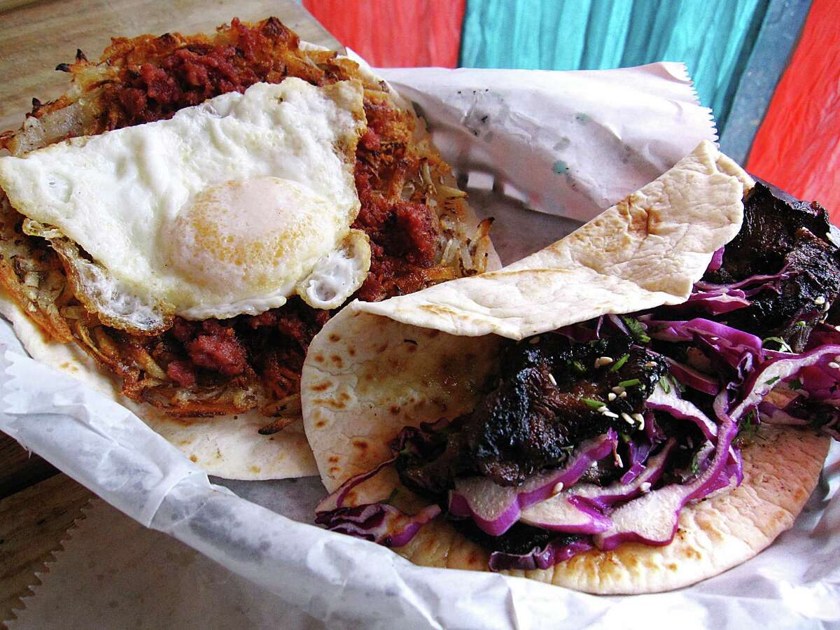 A taco called The Irish, left, with hashbrowns, corned beef and a fried egg, and The Seoul, a taco with bulgogi-style beef, from Saint City Tacos.