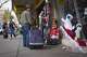 A commuter who has just entered El Paso from Ciudad Juarez, makes a stop to look at Christmas decorations while he carries his suitcase.