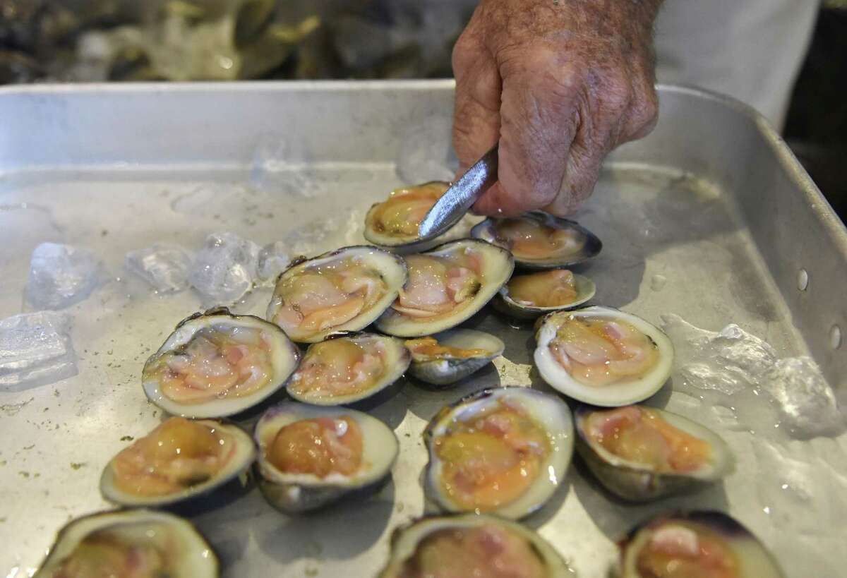 Atlantic Clam Farms owner Ed Stilwagen prepares clams during a First Science Sunday event at Greenwich Point Park's Floren Family Environmental Center in Old Greenwich, Conn. last year.