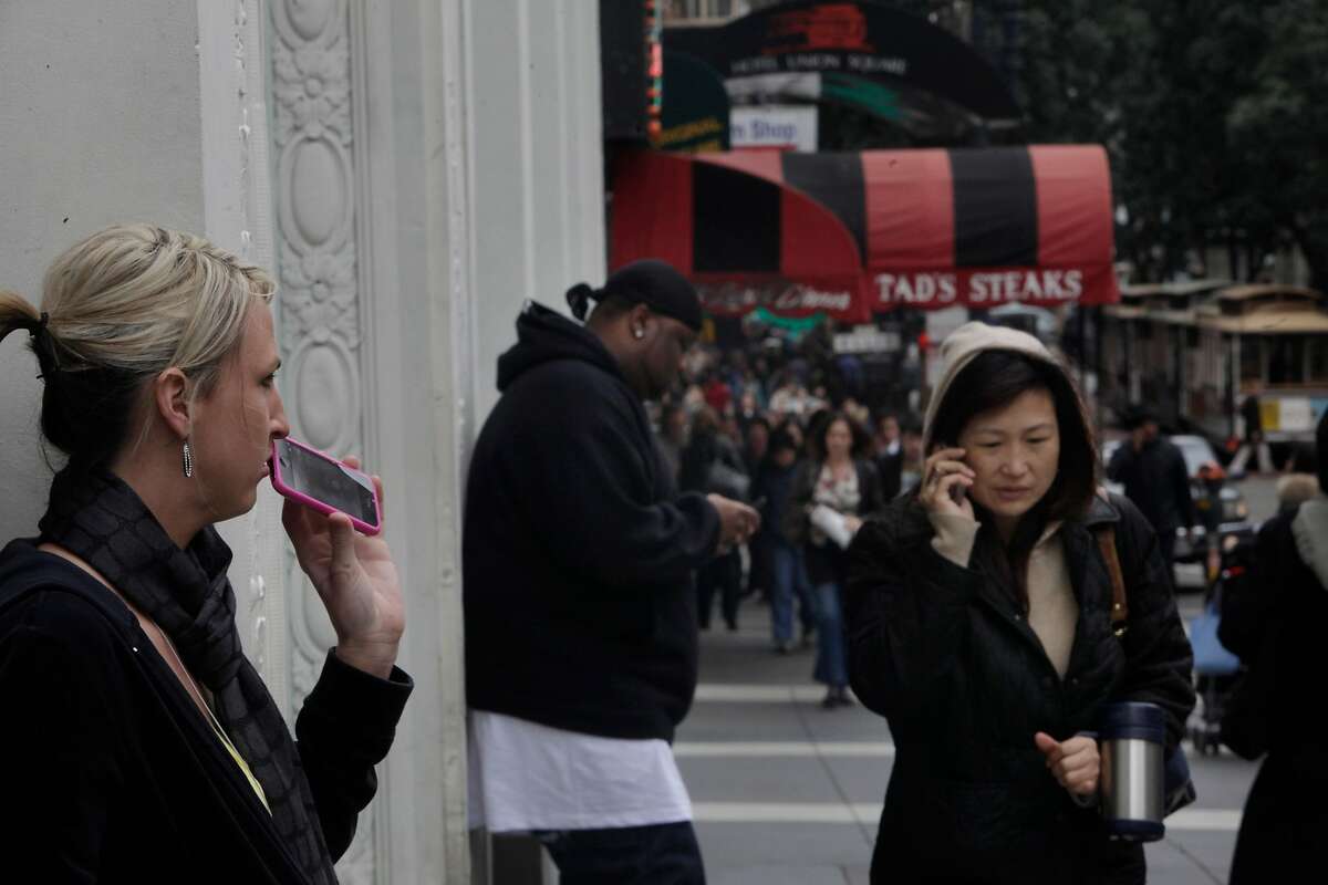 Powell Street pedestrians on their cell phones. A new study from Kaiser showed that radiation from cell phones and wi-fi networks greatly increases the risk of miscarriage, joining a body of research linking this radiation to damage in humans.
