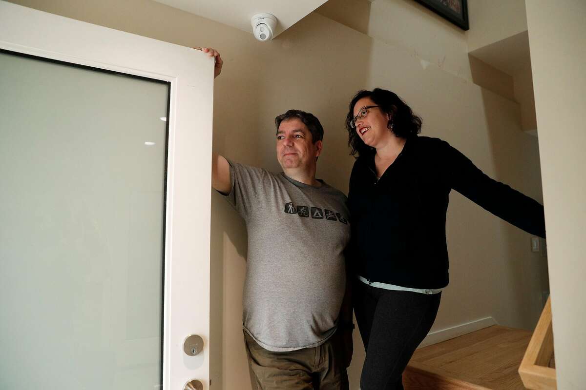 Alice Petty and Jason Hogg look out the front door of their home in San Francisco, Calif., on Tuesday, December 19, 2017. The couple installed a security video system in their Glen Park home, and recently capturing video of a porch pirate opening a package and stealing a keyboard they ordered online. The couple installed a Ring video doorbell, two other cameras, and a series of iPads inside so they can monitor the security video, which is stored on a local network storage drive.
