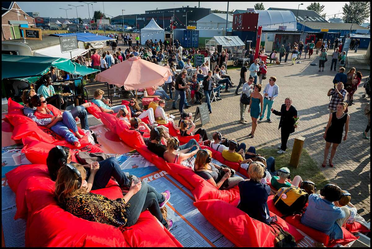 Crowds attend the Over het IJ Festival, an annual theatre festival that brings inspirational theatre and cuisine the Amsterdam Noord area every July.