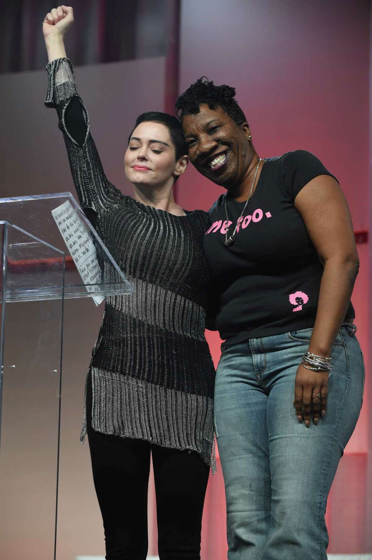 Rose McGowan and Tarana Burke stand on stage at The Women's Convention in October in Detroit. Burke started using "Me Too" a decade ago to raise awareness about sexual violence.