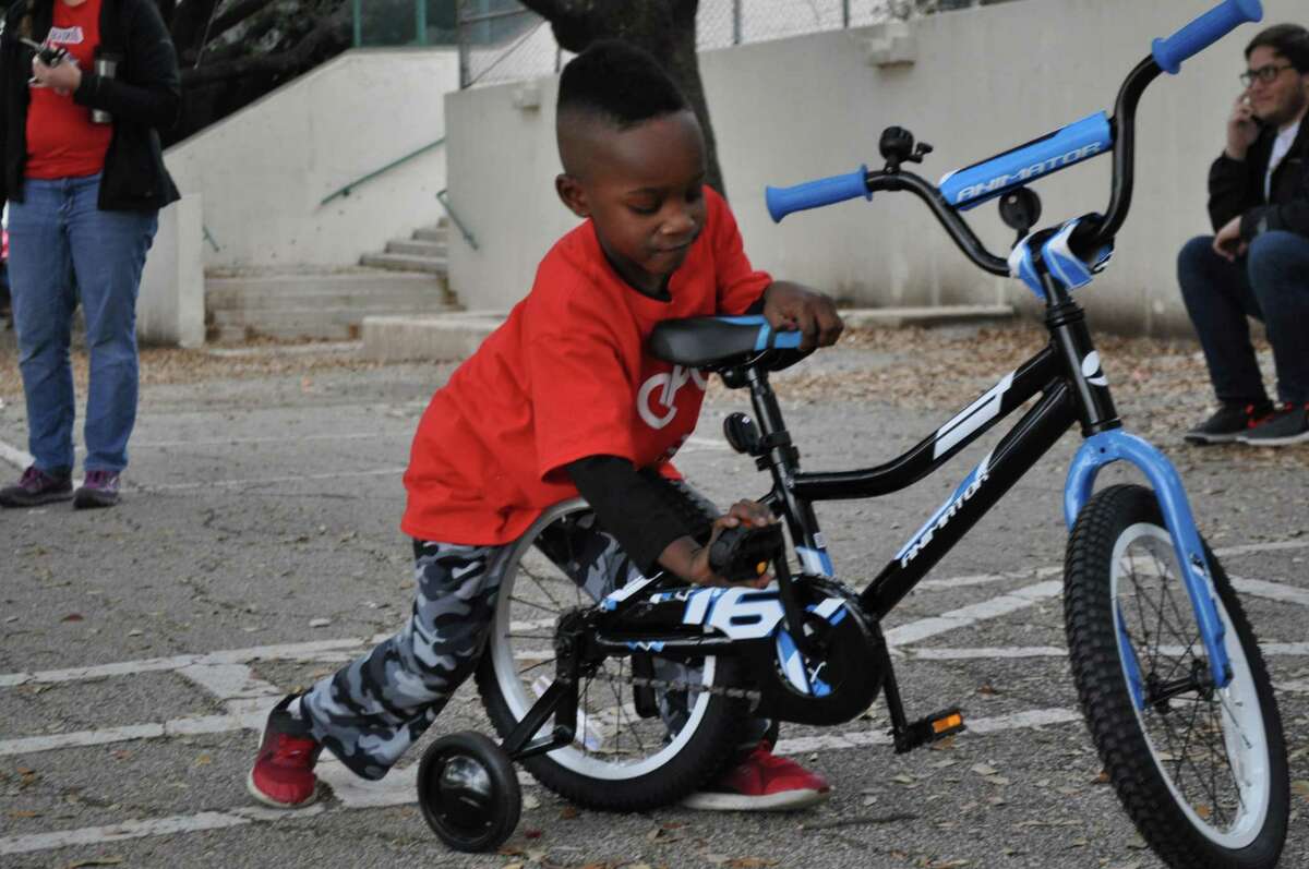 Jayden Griffin, 5, checks out his new bike, which he built through the program, Earn-A-Bike.