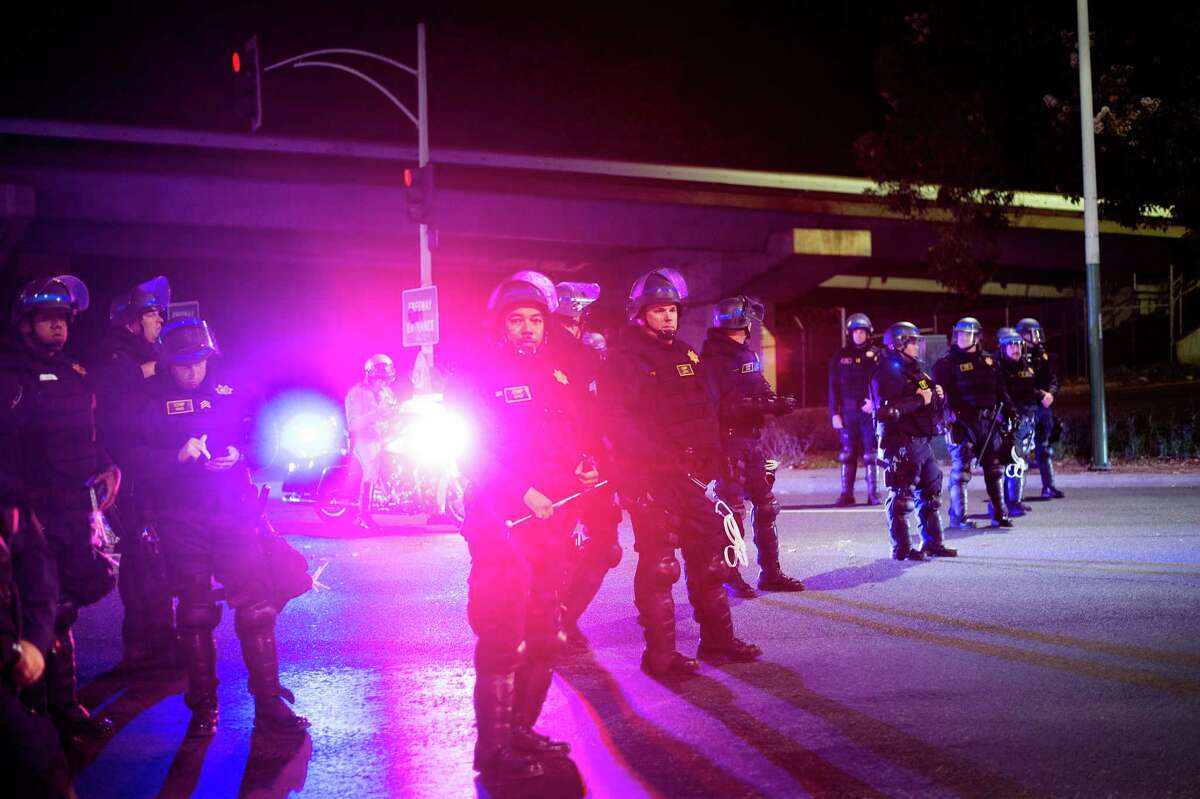 Oakland officers guard a freeway entrance near where protesters were marching against Donald Trump’s election Nov. 12, 2016.