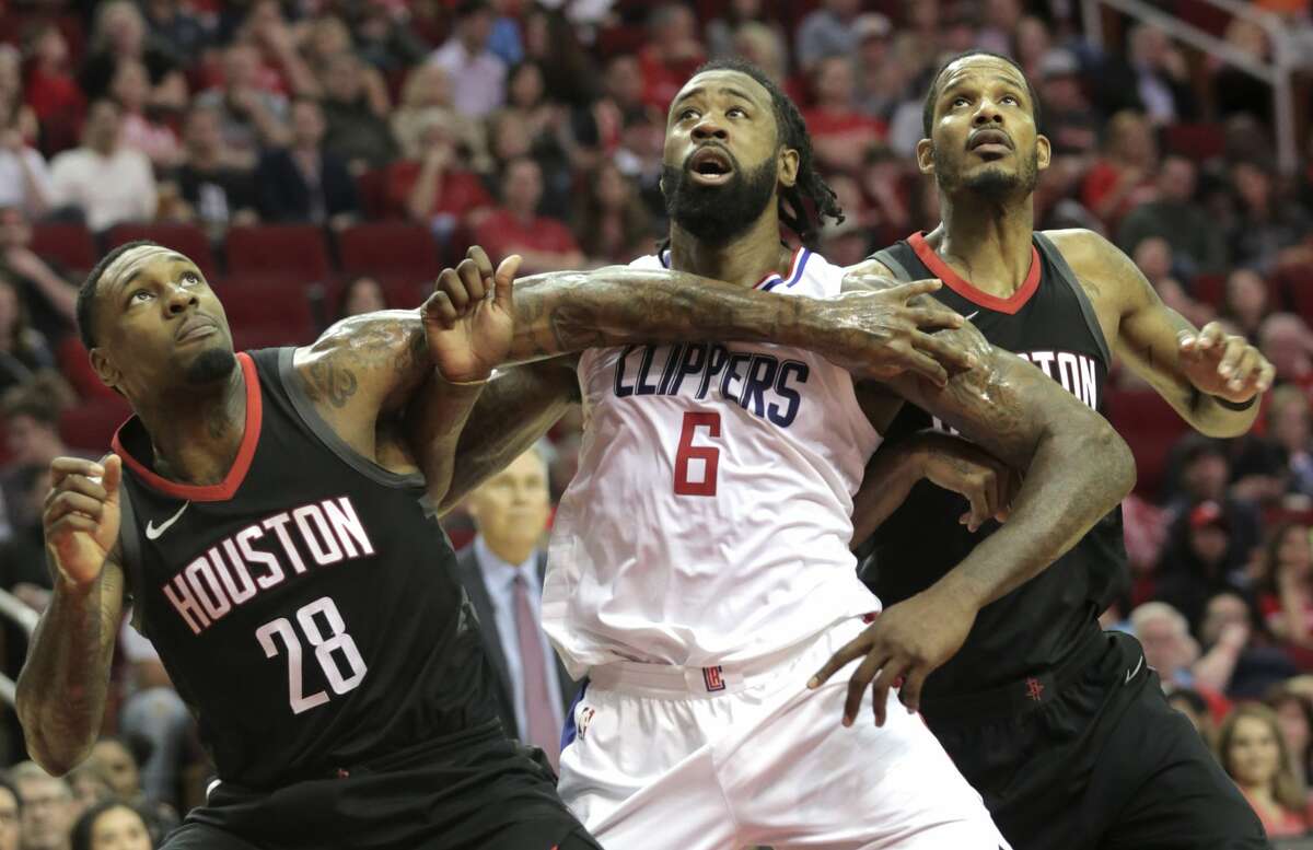 Houston Rockets forward Tarik Black (28) boxes out LA Clippers center DeAndre Jordan (6) with teammate Trevor Ariza (1) during the second half at the Toyota Center on Friday, Dec. 22, 2017, in Houston. Clippers won the game 128-118. ( Elizabeth Conley / Houston Chronicle )
