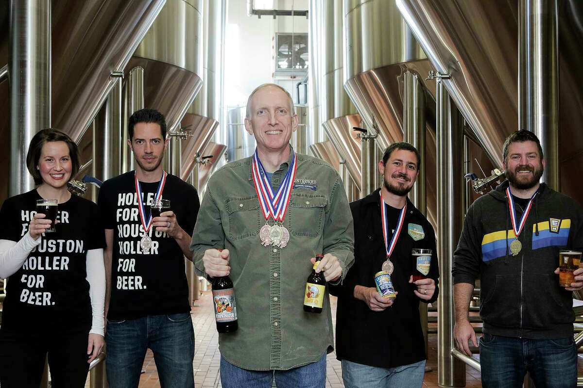 Award-winning Houston brewers pose for a photo at Saint Arnold Brewing Co. on Friday, Dec. 8, 2017, in Houston. They include Karhryn (from left) and John Holler of Holler Brewing, Brock Wagner, owner of Saint Arnold, Mark Dell'Osso of Galveston Island Brewing and Casey Motes of Eureka Heights Brew Co. ( Elizabeth Conley / Houston Chronicle )