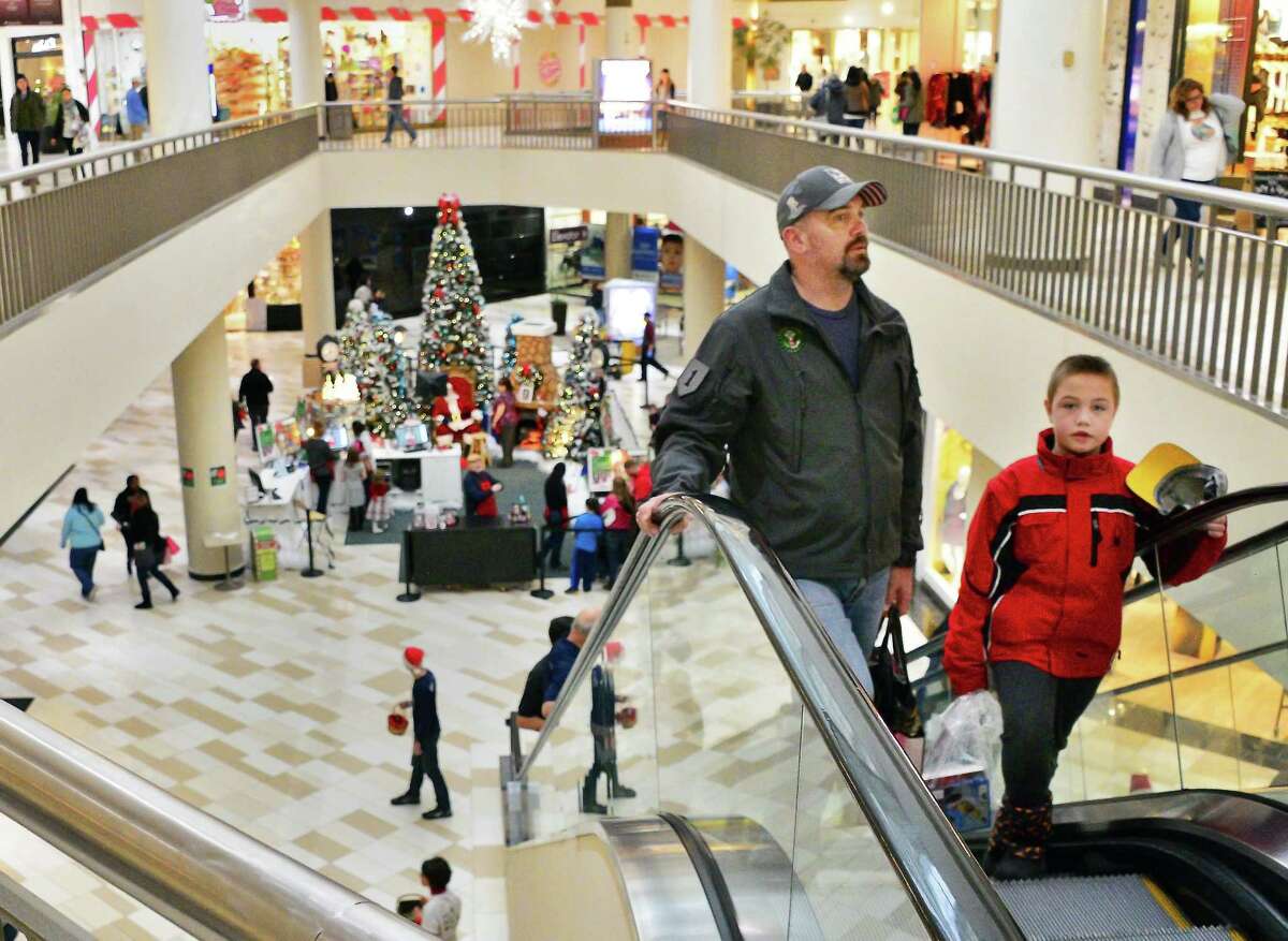 George Weiderkehr of Princetown and his son Hans, 8, do some last minute holiday shopping at Crossgates Mall Saturday Dec. 23, 2017 in Guilderland, NY. (John Carl D'Annibale / Times Union)