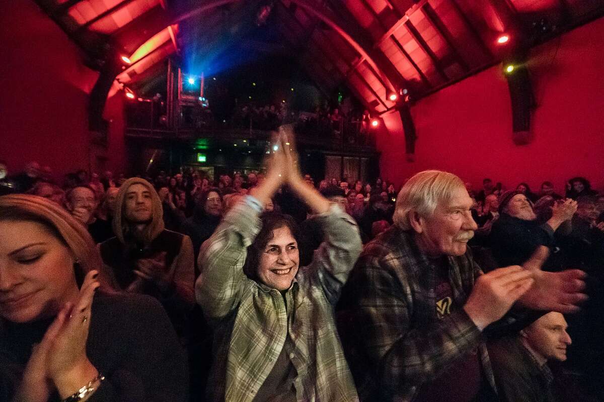 Lynda Lunkley applauds for Country Joe McDonald during a 2017 show in San Francisco, which plans to allow indoor live events to resume on April 15 with limited capacity.