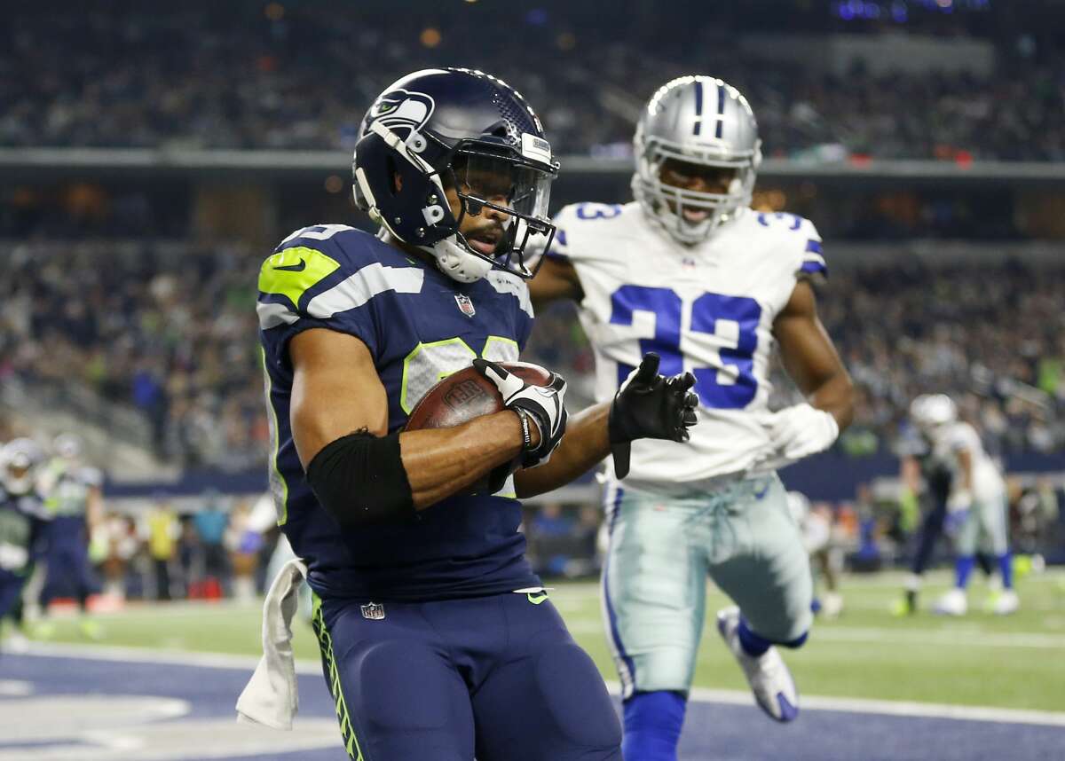 Seattle Seahawks wide receiver Doug Baldwin (89) catches a touchdown pass in front of Dallas Cowboys' Chidobe Awuzie (33) in the second half of an NFL football game, Sunday, Dec. 24, 2017, in Arlington, Texas. (AP Photo/Ron Jenkins)