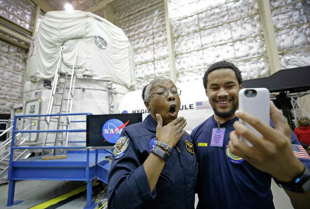 Karen Brun, left, with her son Frankie Brun, reacts while talking to her daughter on FaceTime after spending 45 days inside NASA's HERA. ﻿