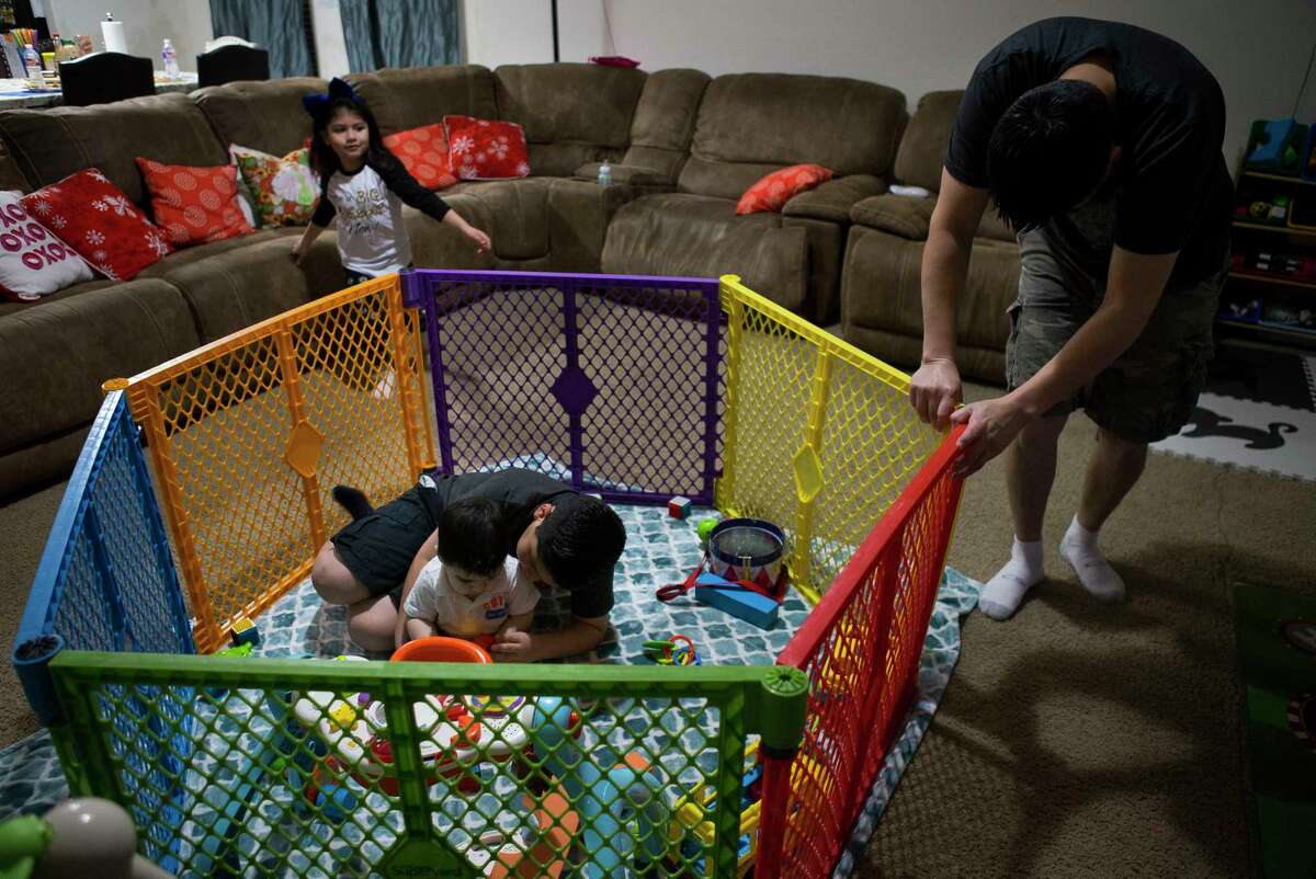 Abraham Romero plays with his ten-month-old brother, Sebastian, Wednesday, Dec. 13, 2017, in Katy. Sebastian was born with Severe Combined Immunodeficiency Disorder, or SCID, and received a stem cell transplant earlier this year from Blanca that should help him build cells that will fight infections on their own. In the meantime the family is taking every precaution. Sebastian stays at home, and he is only handled by family members. Blanca had a cold earlier in the week, and even though she is currently on antibiotics, she is wearing a mask when close to Sebastian.