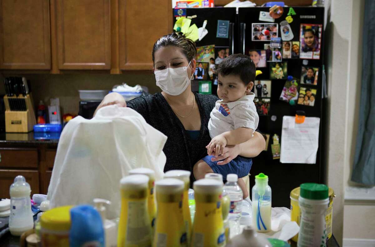 Blanca Romero prepares a bottle for her son Sebastian at home in Katy. Sebastian, who was born without a functioning immune system, received a stem cell transplant from his mother that should help him build cells that will fight infections.