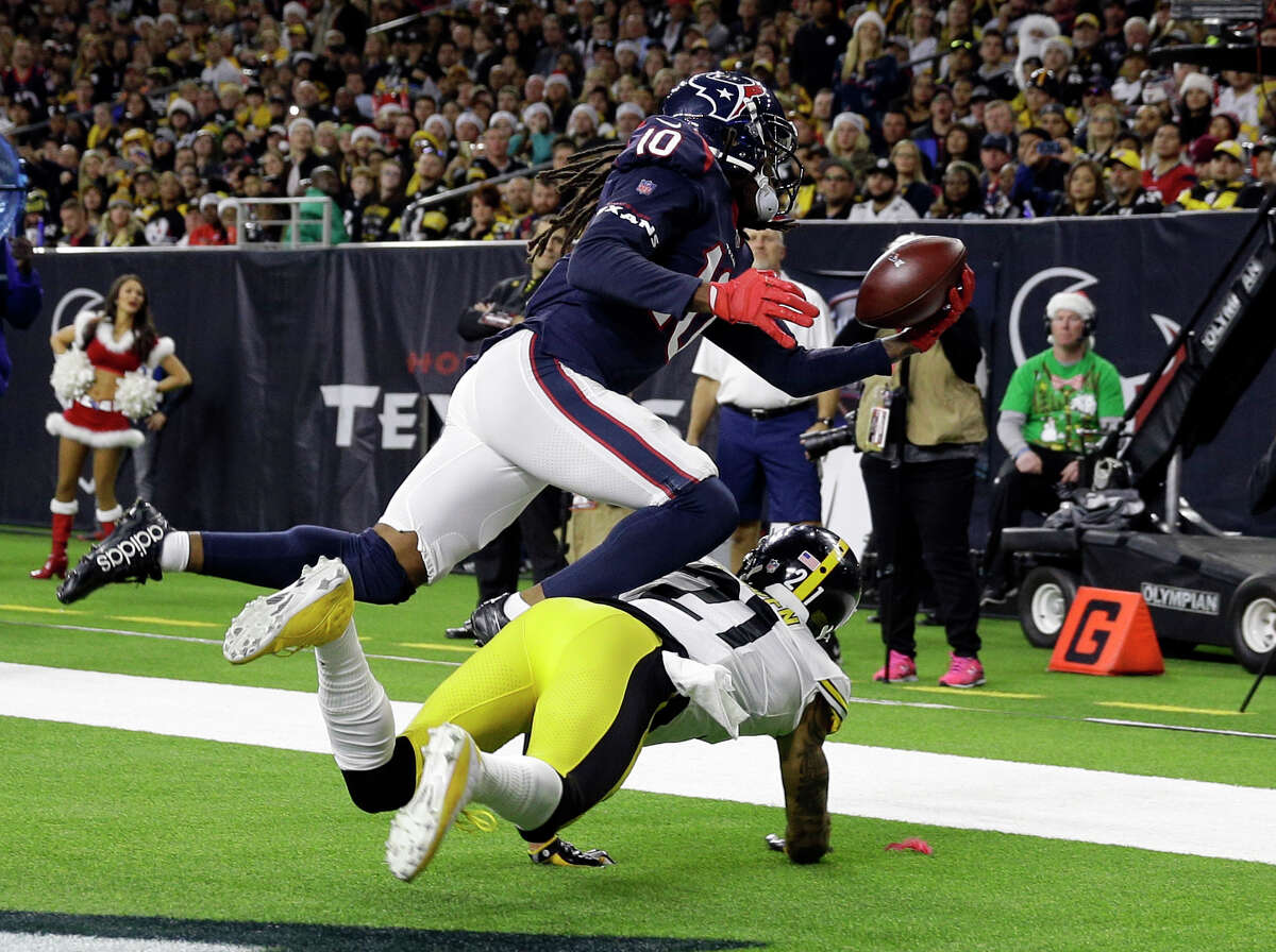 Houston Texans wide receiver DeAndre Hopkins (10) catches a pass for a touchdown as Pittsburgh Steelers cornerback Joe Haden (21) defends during the second half of an NFL football game Monday, Dec. 25, 2017, in Houston. (AP Photo/Michael Wyke)
