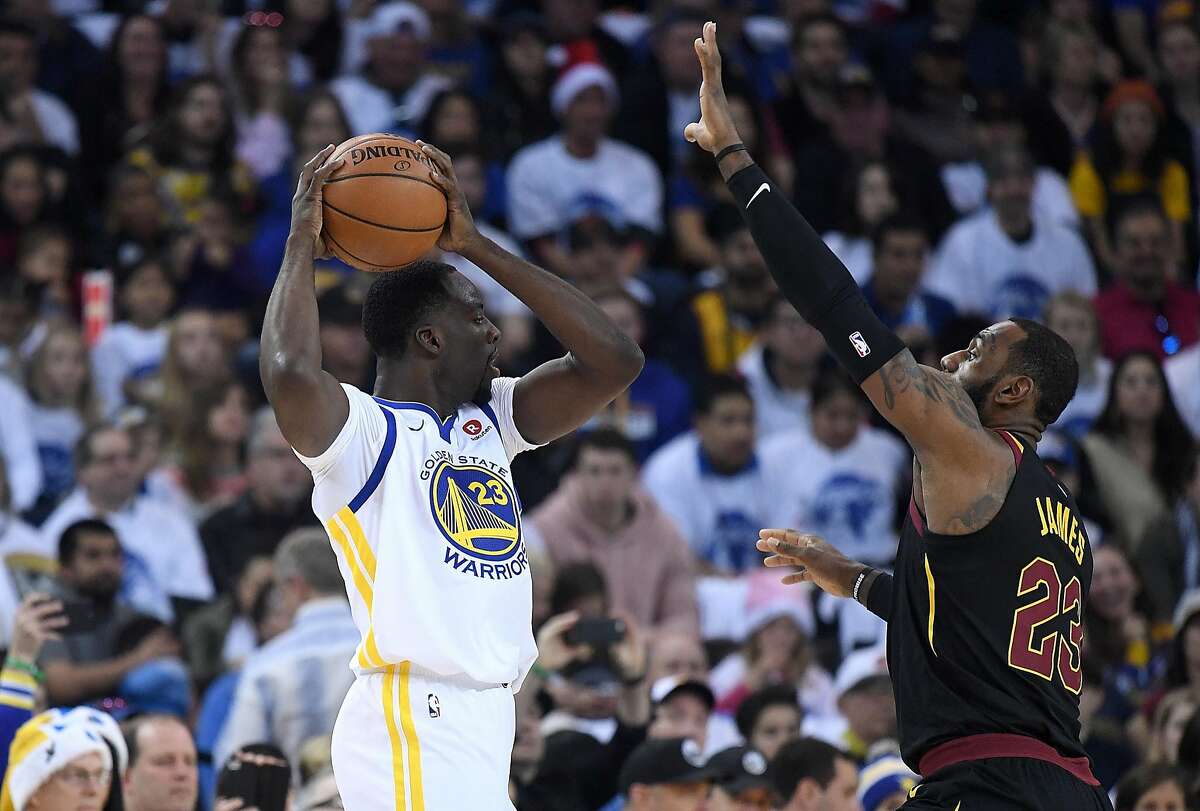 OAKLAND, CA - DECEMBER 25: Draymond Green #23 of the Golden State Warriors looks to pass the ball over the top of LeBron James #23 of the Cleveland Cavaliers during an NBA basketball game at ORACLE Arena on December 25, 2017 in Oakland, California. NOTE TO USER: User expressly acknowledges and agrees that, by downloading and or using this photograph, User is consenting to the terms and conditions of the Getty Images License Agreement. (Photo by Thearon W. Henderson/Getty Images)