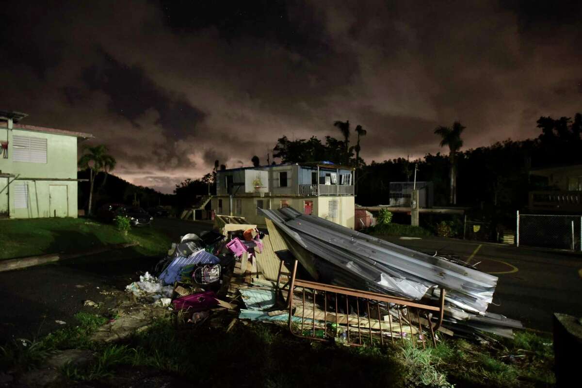 A mountain of rubble remains in front of a home in Morovis, Puerto Rico. By 4 p.m., some generators in the neighborhood start rumbling to life as darkness approaches. ﻿