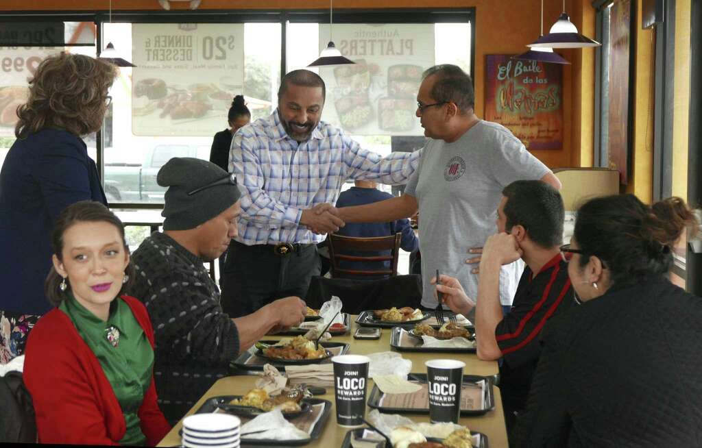 Atour Eyvazian, left, owner of El Pollo Loco restaurants, speaks with Pastor Juan Andrade of Victory Outreach International Church at the Pollo Loco restaurant at 4645 W. Commerce St. on Christmas Day, Monday, Dec. 25, 2017. Eyvazian opened this restaurant to the homeless and others for Christmas dinner. Pastor Andrade brought people from his group home to the restaurant to enjoy a free Christmas dinner. Photo: Billy Calzada, Staff / San Antonio Express-News