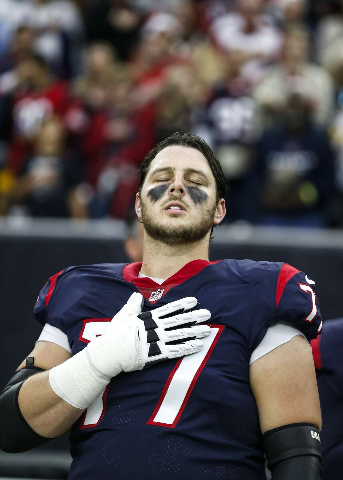 Houston Texans offensive guard David Quessenberry (77) closes his eyes as he stands for the national anthem before an NFL football game against the Pittsburgh Steelers at NRG Stadium on Monday, Dec. 25, 2017, in Houston. ( Brett Coomer / Houston Chronicle )