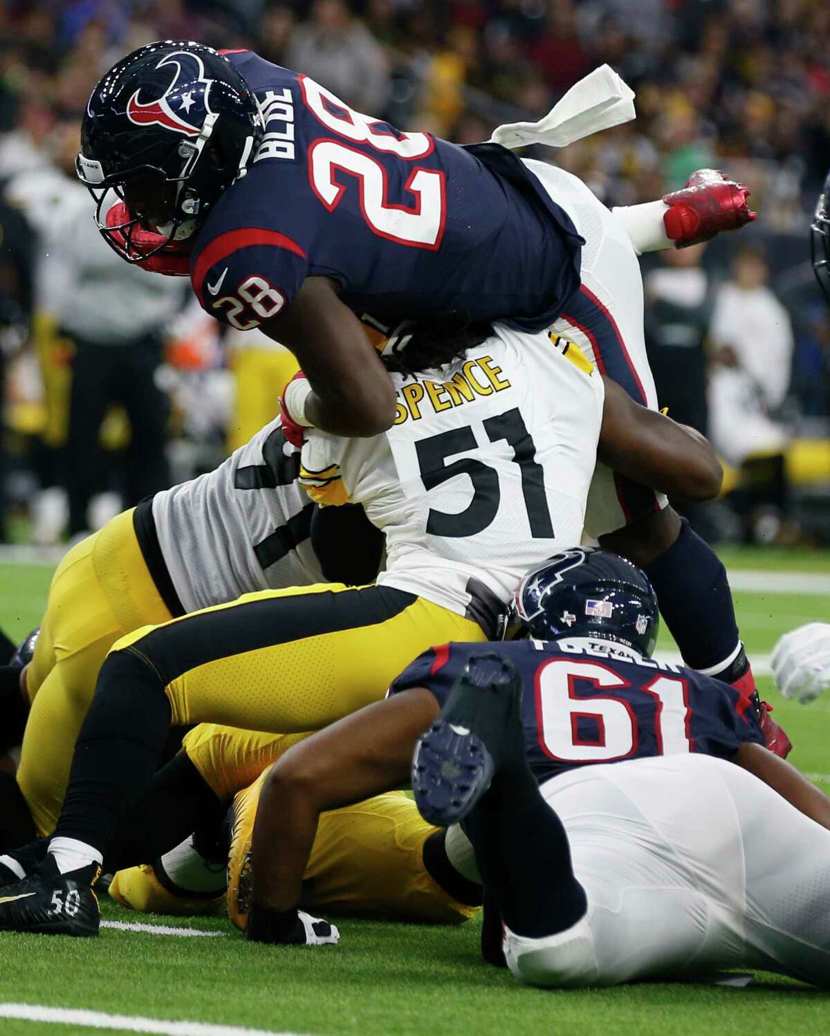 Texans running back Alfred Blue (28) is stopped short of the goal line by Steelers linebacker Sean Spence (51) during the second quarter. Blue carried 16 times for game-high 108 yards.