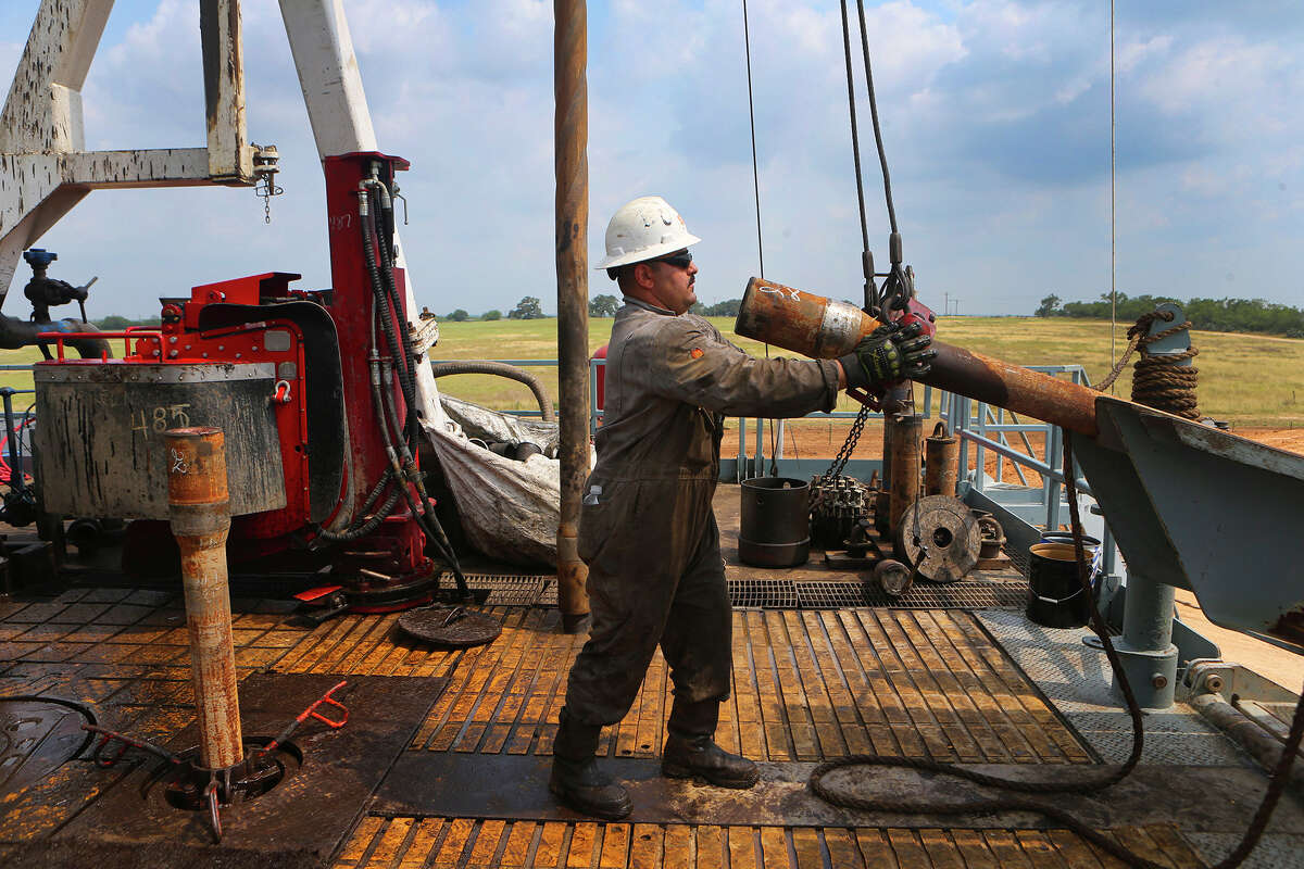Roughneck Eluid ﻿Cervantes pulls up a section of drilling pipe with the help of machinery﻿. Improved technology has been a damper on the oil and gas workforce.
