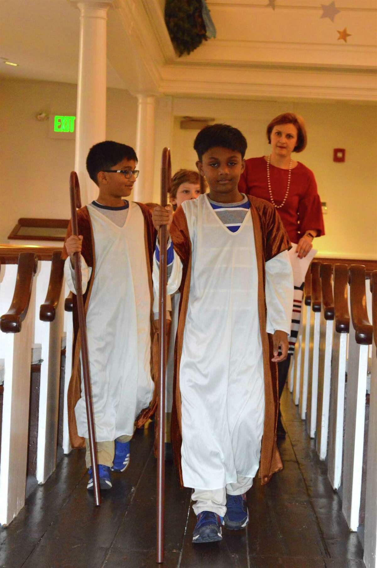 Anit Arvind, 8, of Westport, left, and his twin brother Akil lead the procession of shepherds at the rehearsal for the annual Christmas Eve Pageant at Saugatuck Congregational Church, Sunday, Dec. 24, 2017, in Westport, Conn.