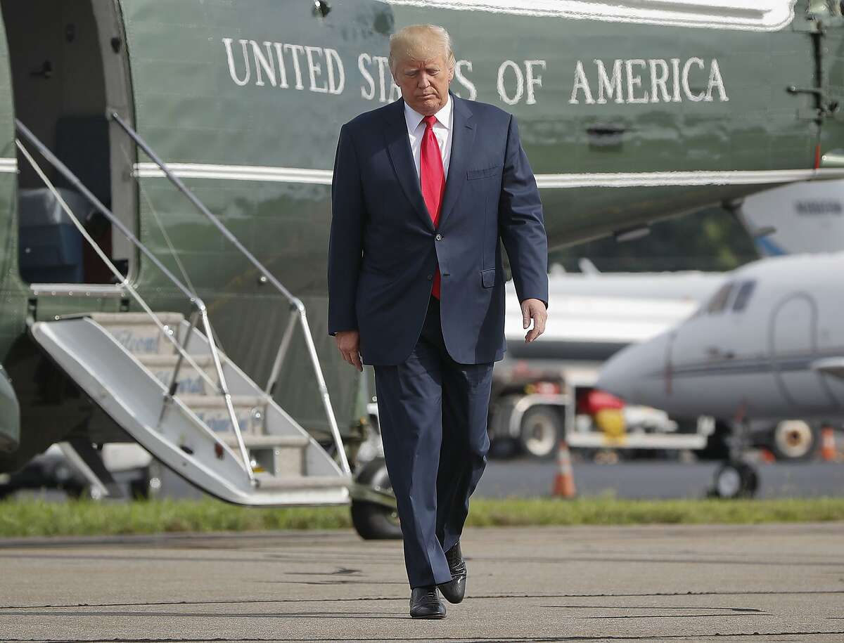 FILE - In this Aug. 14, 2017 file photo, President Donald Trump walks across the tarmac from Marine One to board Air Force One at Morristown Municipal Airport in Morristown, N.J. Bombarded by the sharpest attacks yet from fellow Republicans, President Donald Trump on Thursday, Aug. 17, 2017, dug into his defense of racist groups by attacking members of own party and renouncing the rising movement to pull down monuments to Confederate icons. (AP Photo/Pablo Martinez Monsivais, File)