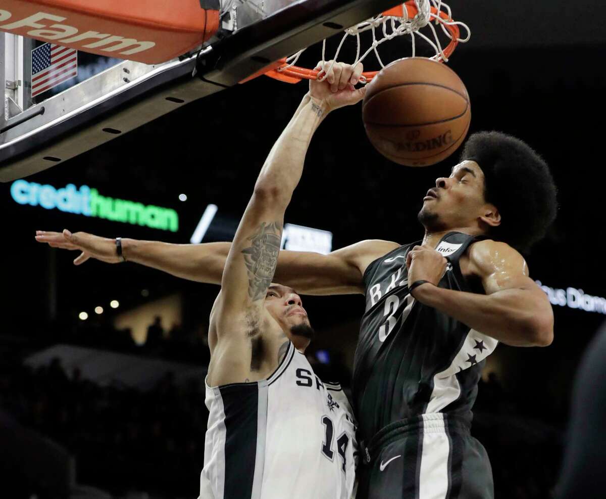 San Antonio Spurs guard Danny Green (14) scores over Brooklyn Nets center Jarrett Allen (31) during the first half of an NBA basketball game, Tuesday, Dec. 26, 2017, in San Antonio. (AP Photo/Eric Gay)