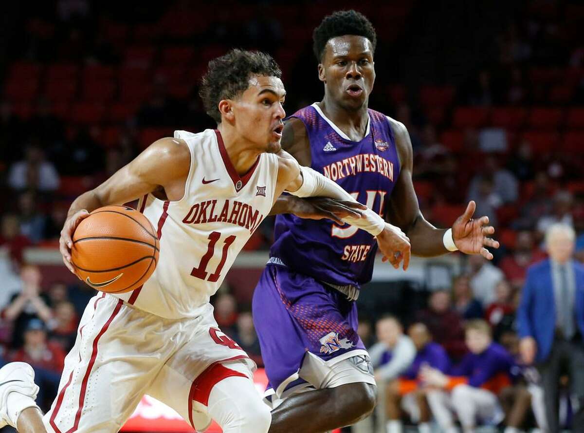 Oklahoma guard Trae Young (11) drives past Northwestern State forward Brandon Hutton, right, during a Dec. 19, 2017 game in Norman, Okla.