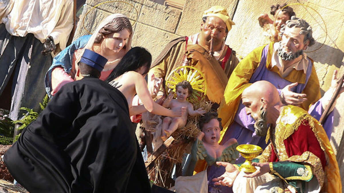 A topless woman from an activist group tried to escape with a baby Jesus statue off of a nativity scene at the Vatican on Christmas Day.