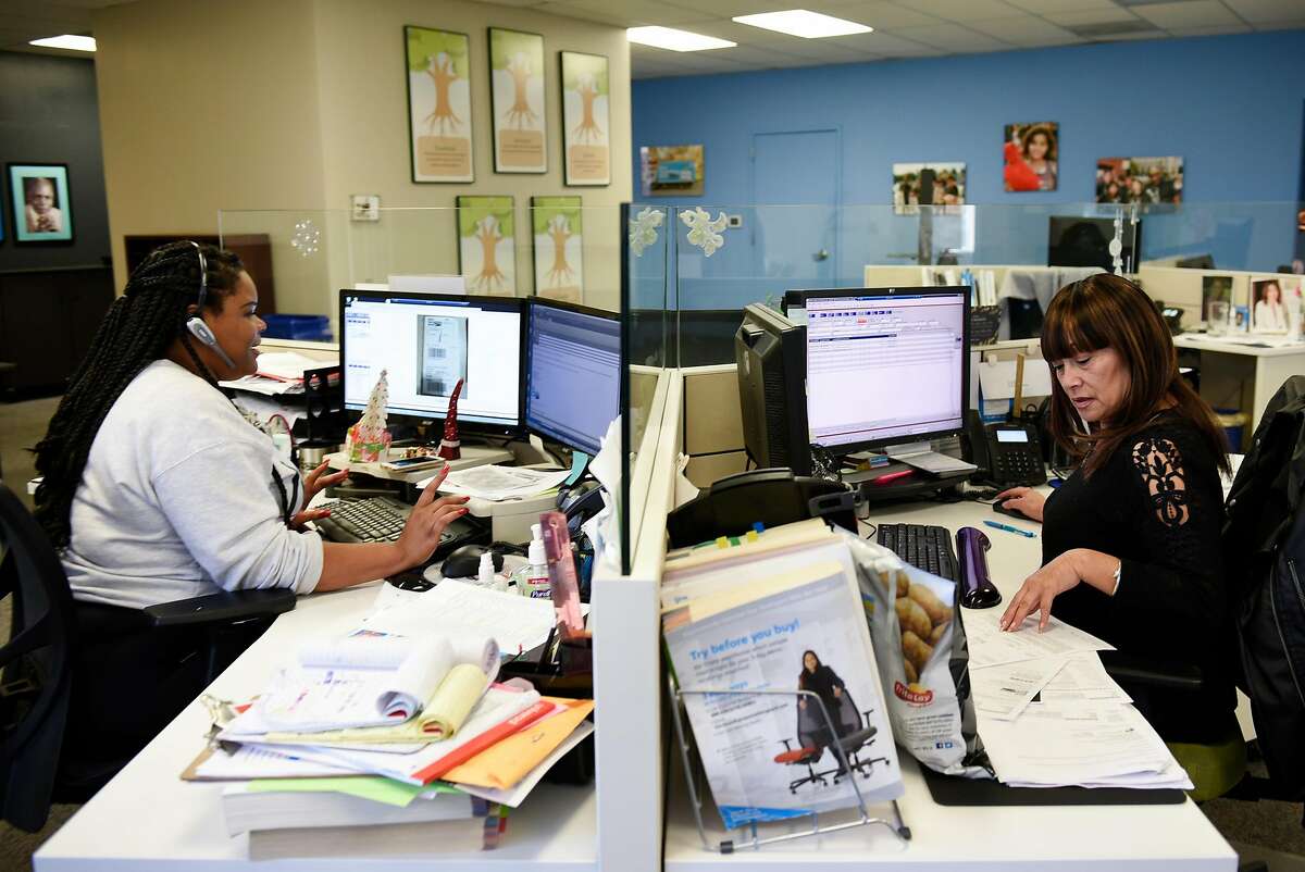Customer relations members Ayanna Grant, left, and Margaretha Bauhuys, work in the customer service department of Give Something Back, in Oakland, Calif., on Wednesday December 27, 2017.