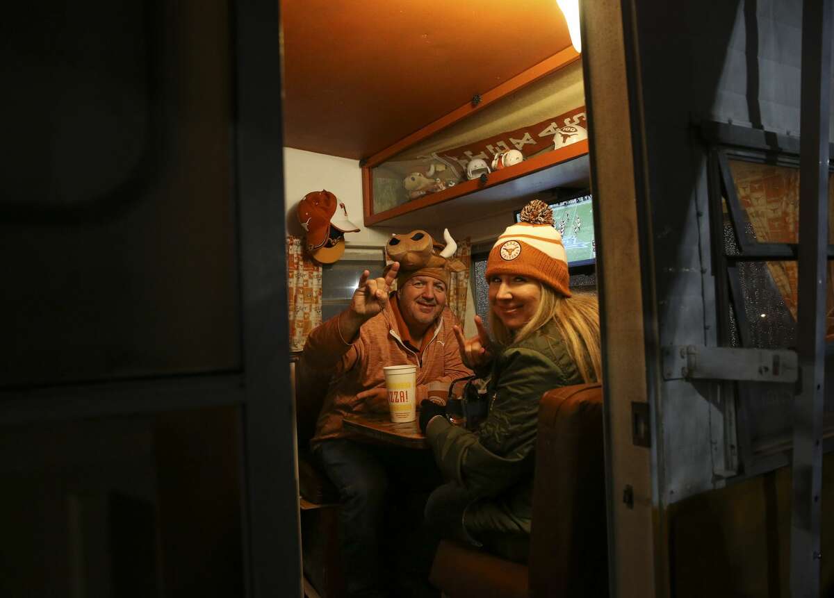 Texas fans Chris Slahetka and Karn Flowers enjoy themselves in a Texas-themed camper while tailgating before the 2017 Academy Sports + Outdoors Texas Bowl at NRG Stadium on Wednesday, Dec. 27, 2017, in Houston. ( Yi-Chin Lee / Houston Chronicle )